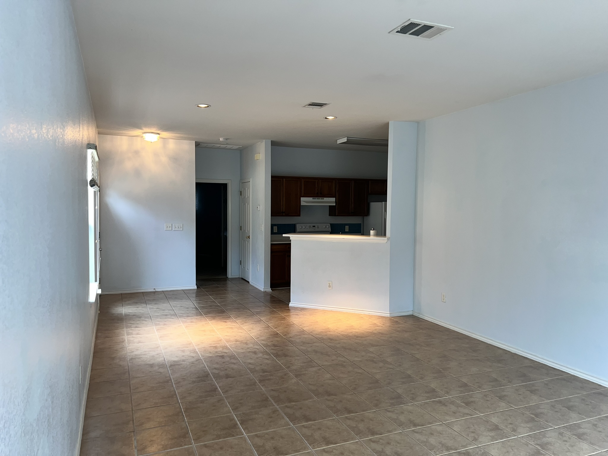 1310 East 3rd Street Georgetown, TX 78626 - Photo 4 of 13 a view of a big room with wooden floor and windows