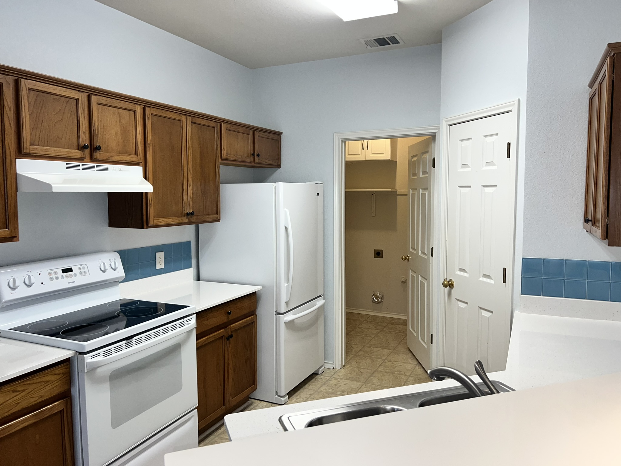 1310 East 3rd Street Georgetown, TX 78626 - Photo 7 of 13 a kitchen with a refrigerator sink and cabinets