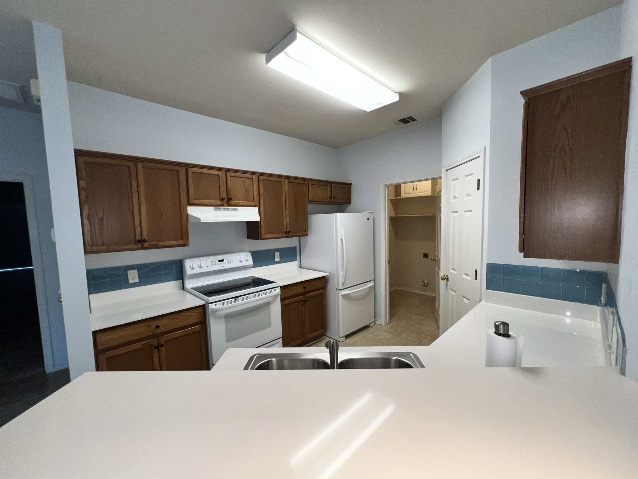 1310 East 3rd Street Georgetown, TX 78626 - Photo 8 of 13 a kitchen with stainless steel appliances a stove a refrigerator and cabinets