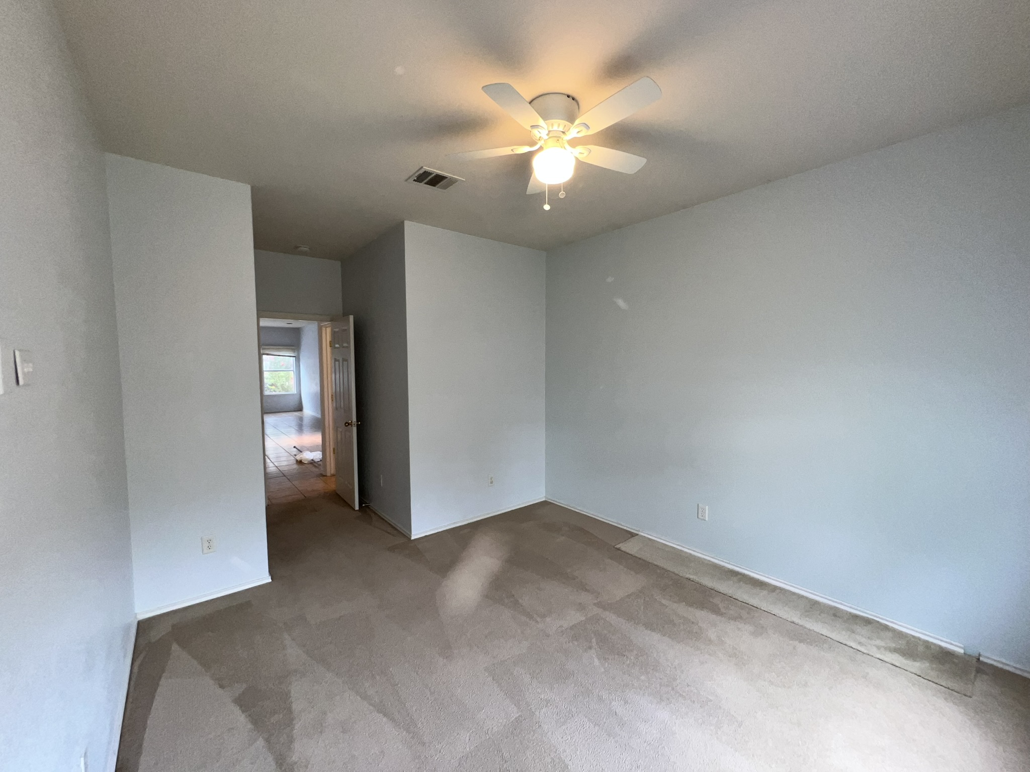 1310 East 3rd Street Georgetown, TX 78626 - Photo 10 of 13 an empty room with chandelier fan and windows