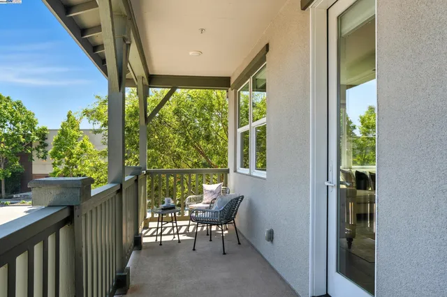 a kitchen with stainless steel appliances kitchen island granite countertop a refrigerator a stove a sink a dining table and chairs