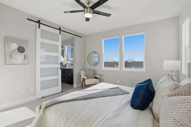 a spacious bathroom with a granite countertop sink mirror and shower