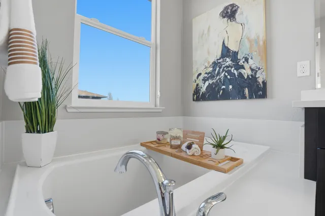 a bedroom with a bed and a painting on the wall