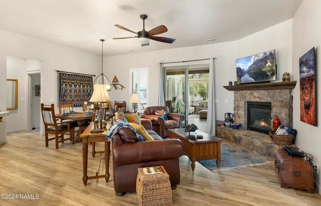 a living room with furniture kitchen view and a fireplace