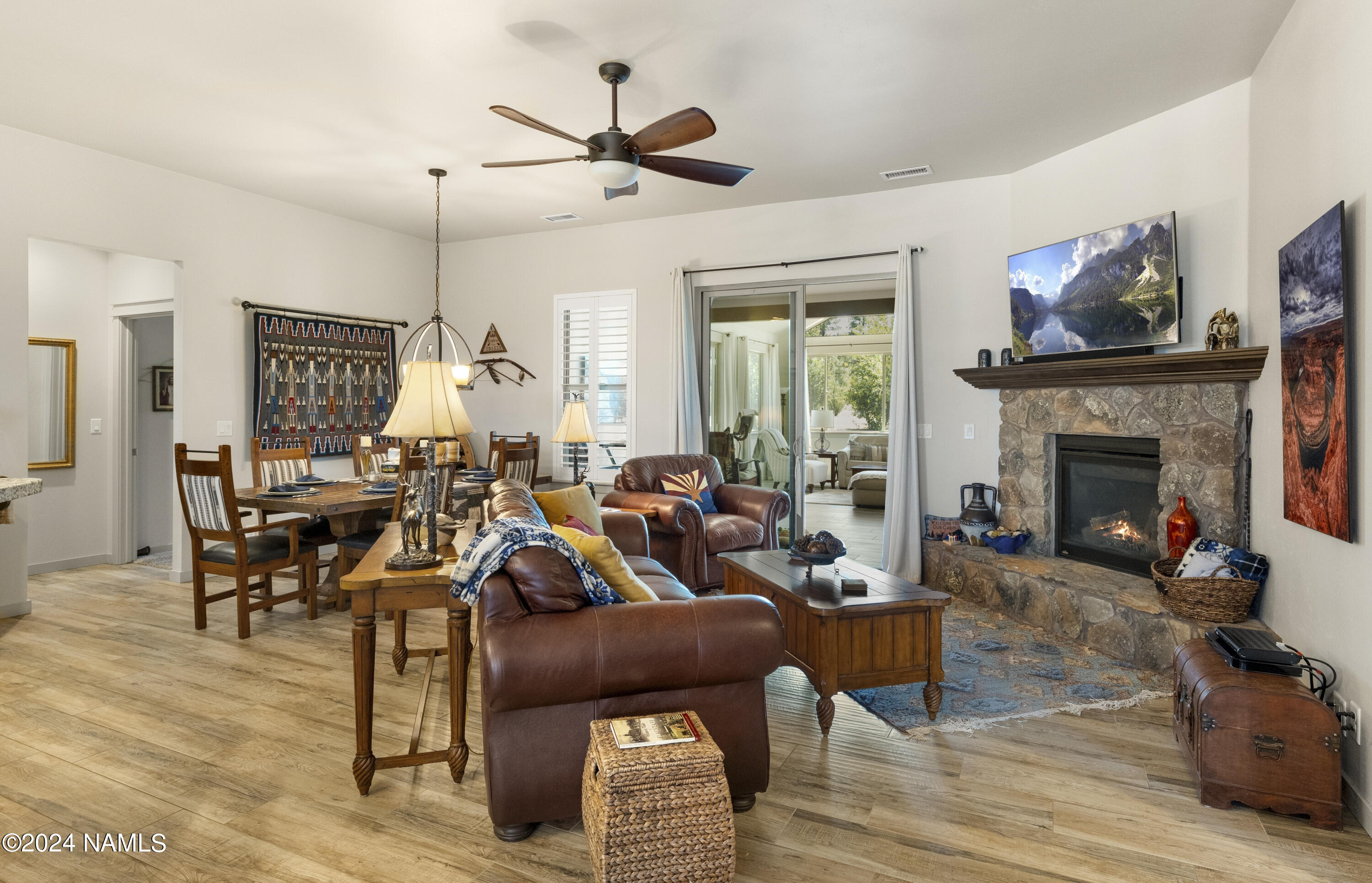 10290 Lundin Road Flagstaff, AZ 86004 - Photo 14 of 43 a living room with furniture kitchen view and a fireplace