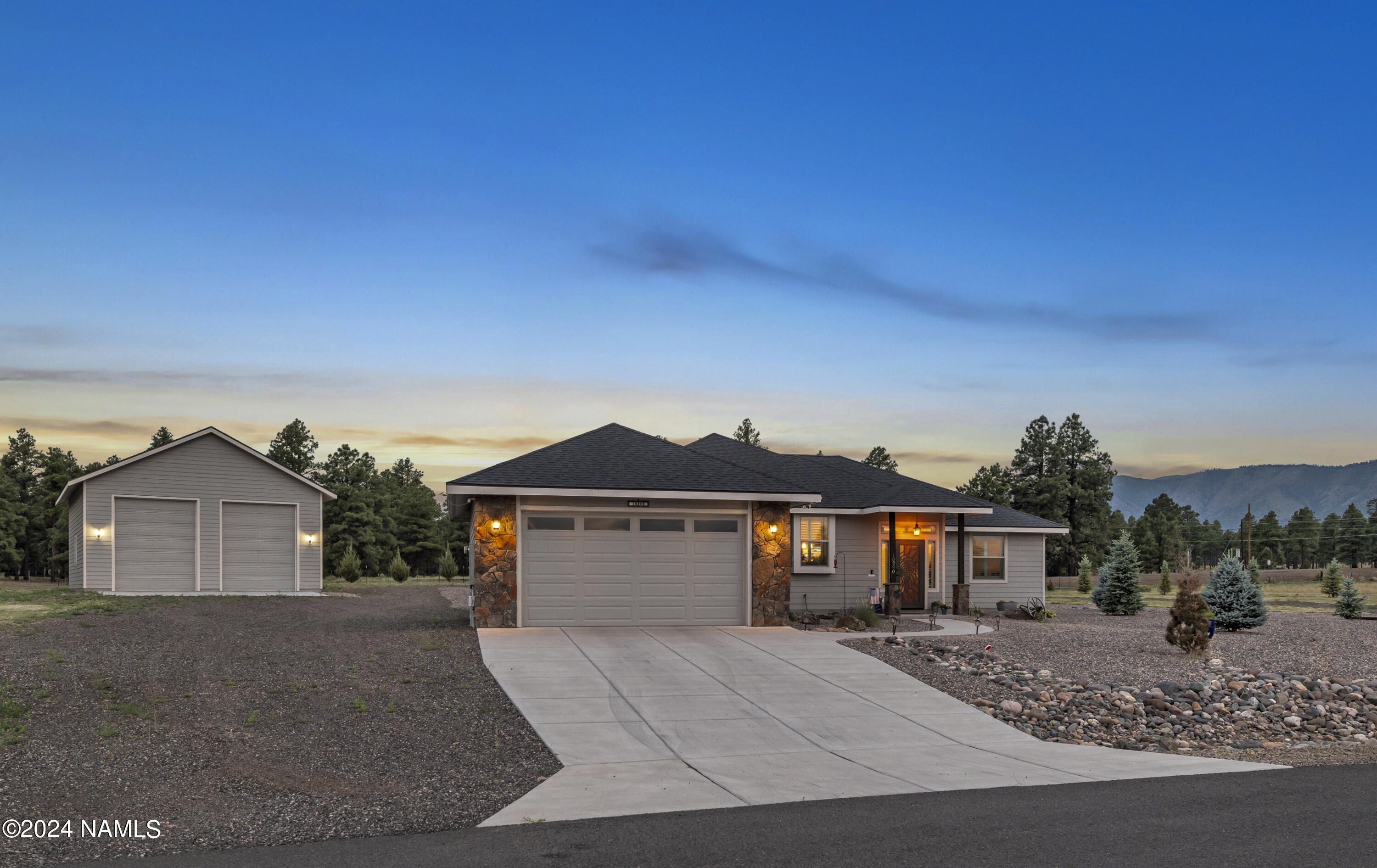 10290 Lundin Road Flagstaff, AZ 86004 - Photo 2 of 43 a front view of a house with a yard and garage