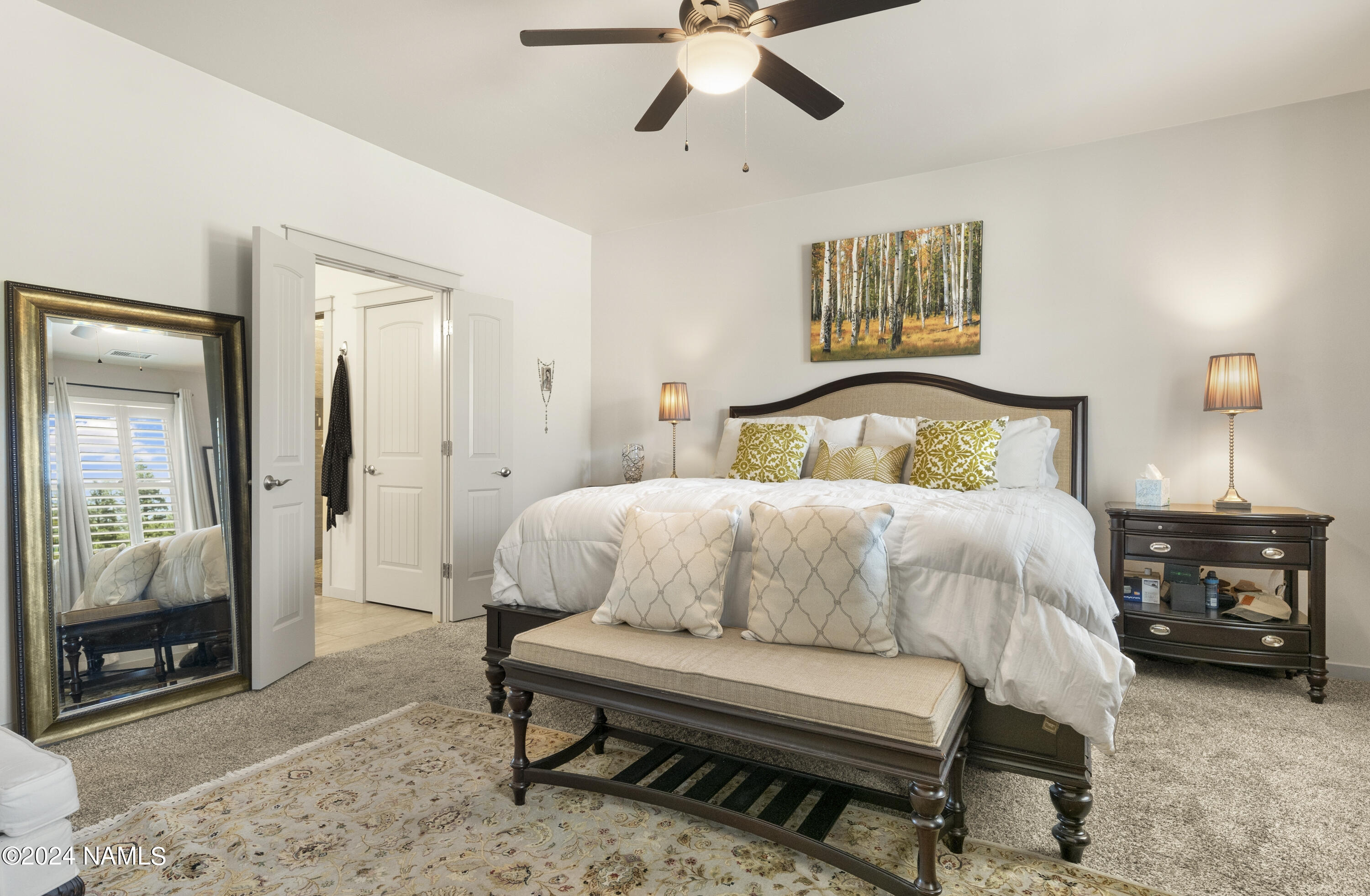 10290 Lundin Road Flagstaff, AZ 86004 - Photo 22 of 43 a bedroom with a bed and a mirror