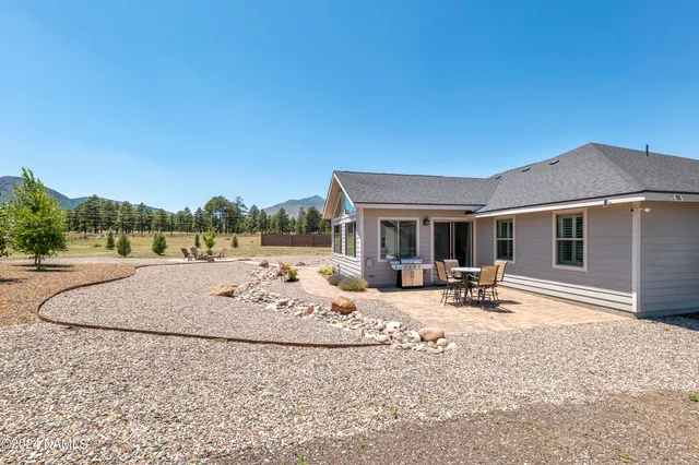 a view of a house with backyard porch and sitting area