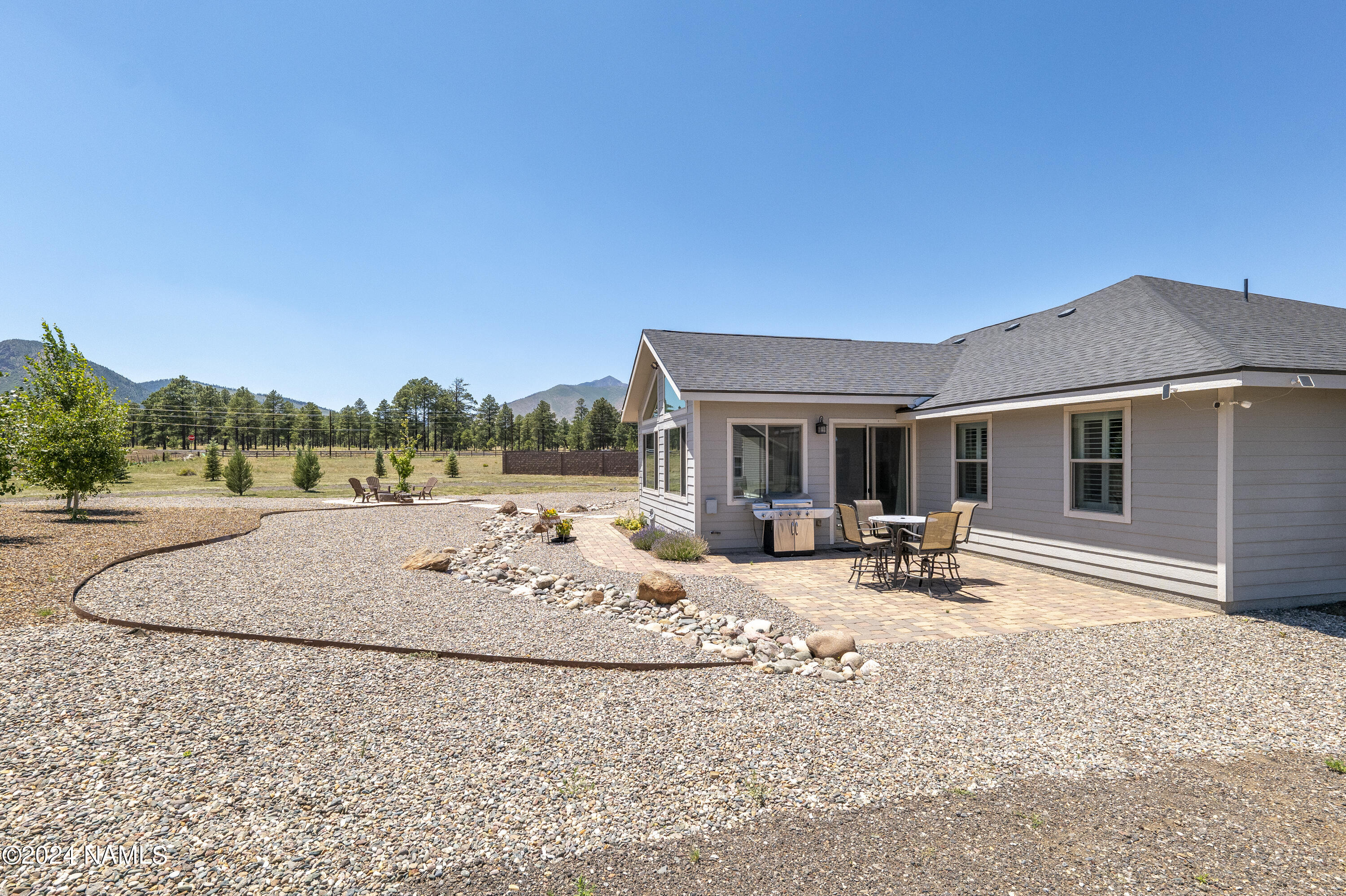 10290 Lundin Road Flagstaff, AZ 86004 - Photo 31 of 43 a view of a house with backyard porch and sitting area