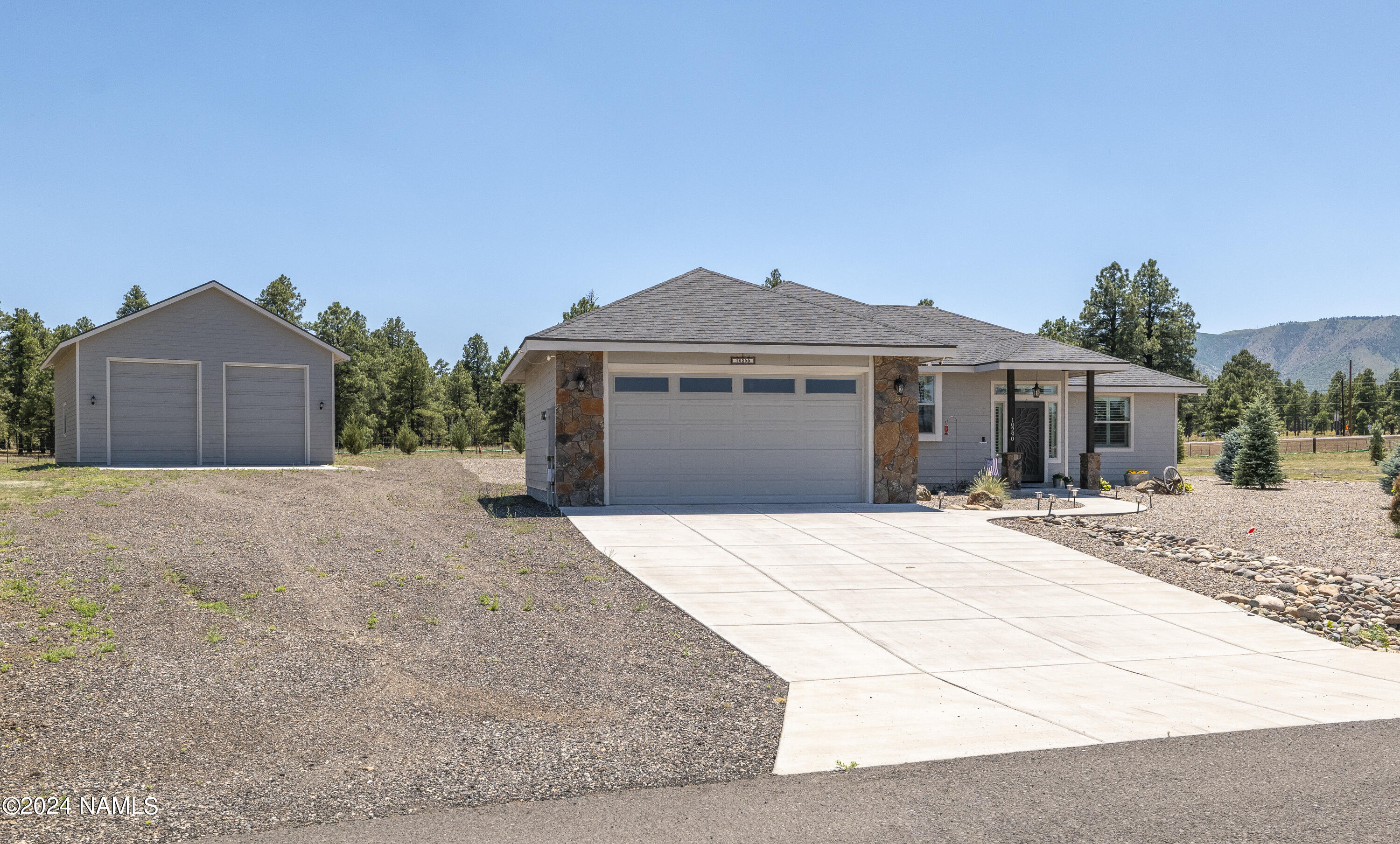 10290 Lundin Road Flagstaff, AZ 86004 - Photo 10 of 43 a front view of a house with a garden