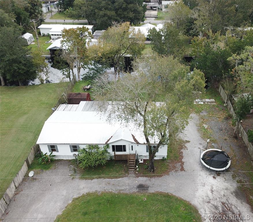 56402 Cherry Tree Road Astor, FL 32102 - Photo 1 of 6 an aerial view of a house with backyard space and lake view