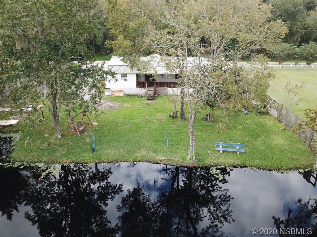 56402 Cherry Tree Road Astor, FL 32102 - Photo 3 of 6 a large green field with lots of trees