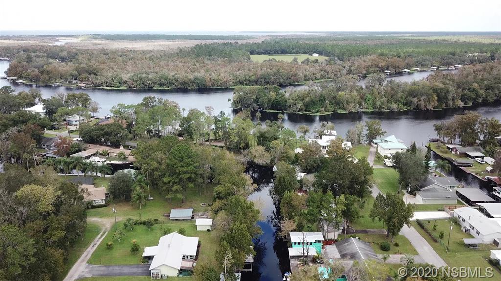 56402 Cherry Tree Road Astor, FL 32102 - Photo 4 of 6 an aerial view of house with yard and lake view