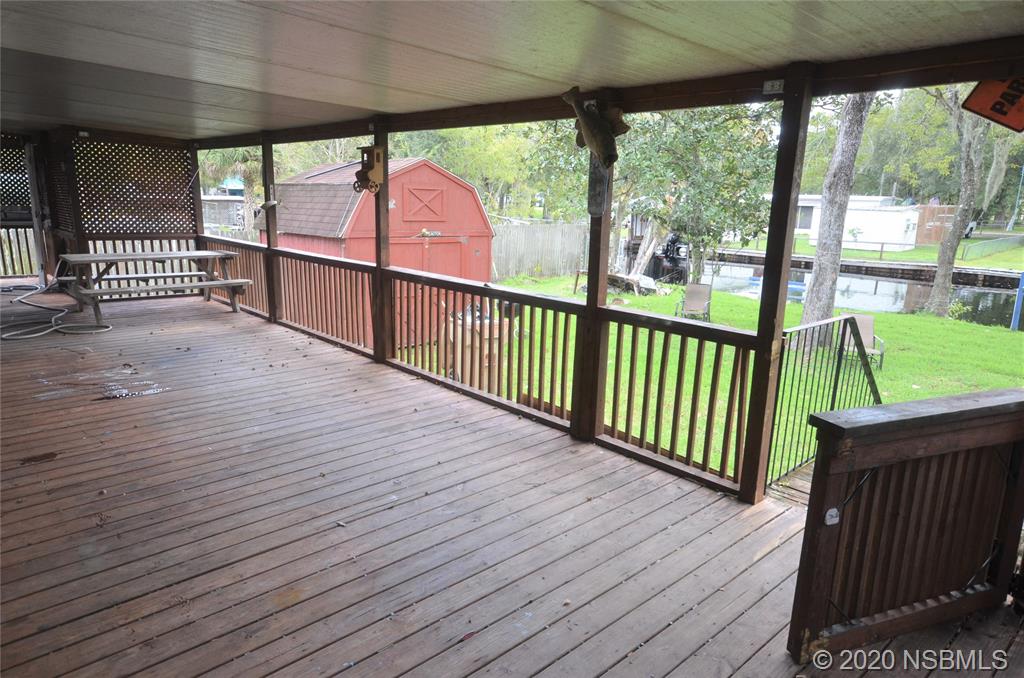 56402 Cherry Tree Road Astor, FL 32102 - Photo 6 of 6 a view of a porch with wooden floor