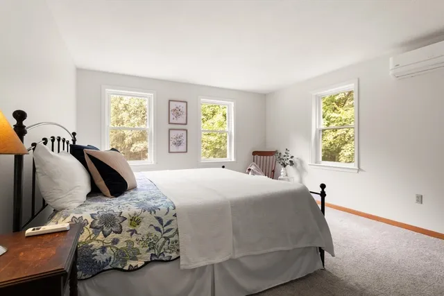 a bedroom with a bed and window