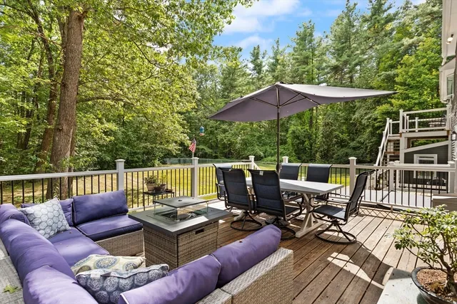 a view of a patio with couches chairs and wooden floor