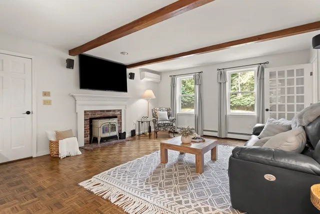 a living room with furniture a fireplace and a flat screen tv