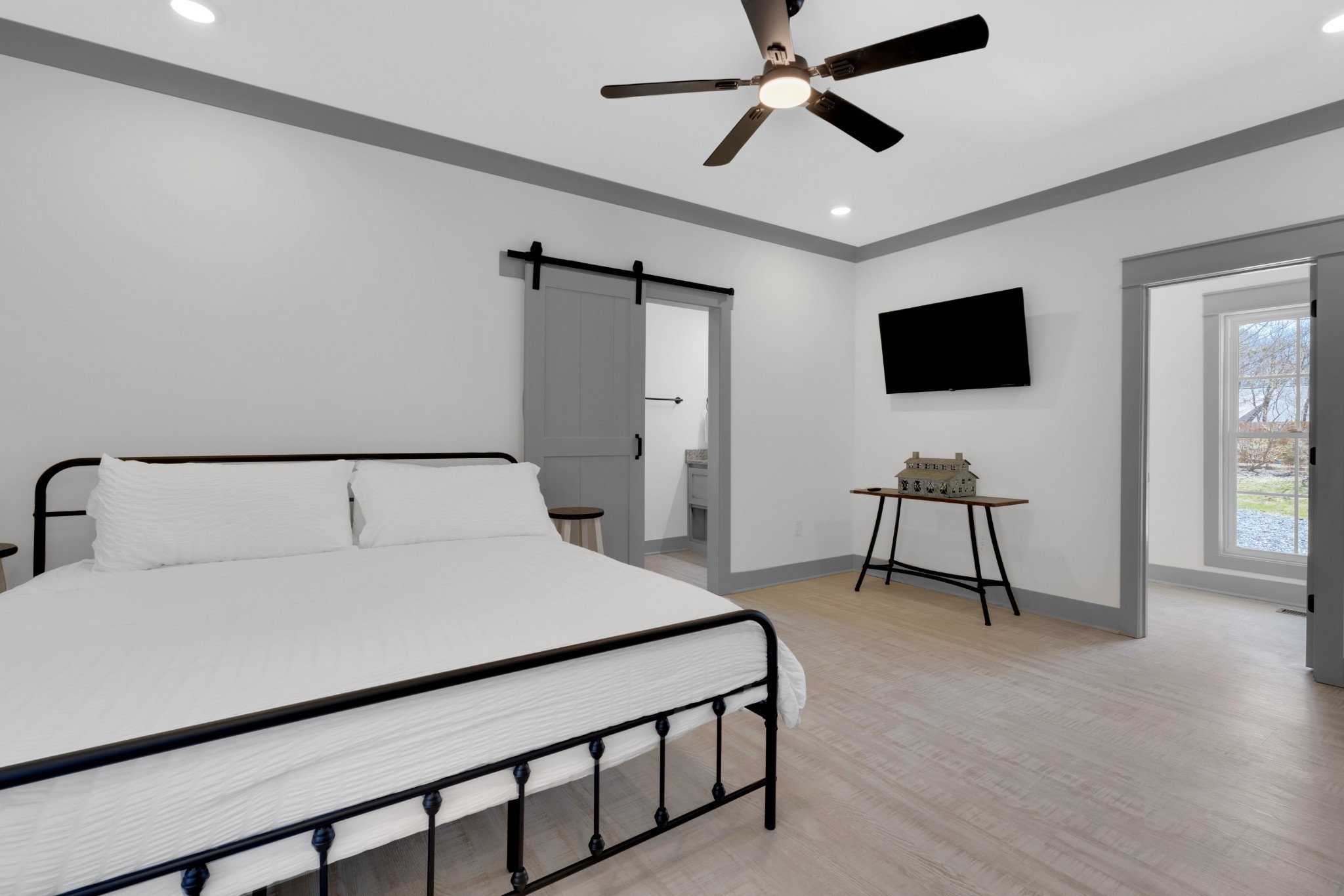 555 Ghea Road Normandy, TN 37360 - Photo 31 of 43 a bedroom with a bed a flat screen tv and a chandelier