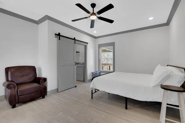 a bedroom with a bed and a chair
