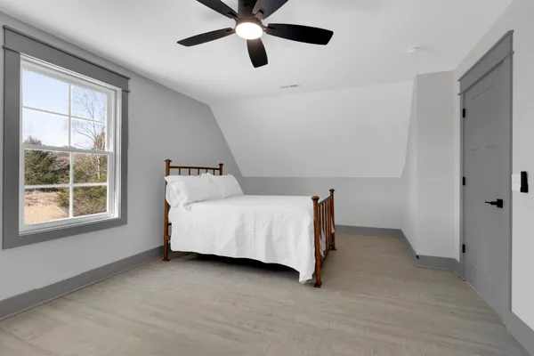 a bedroom with a bed and window