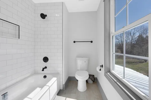 a bathroom with a toilet and a shower