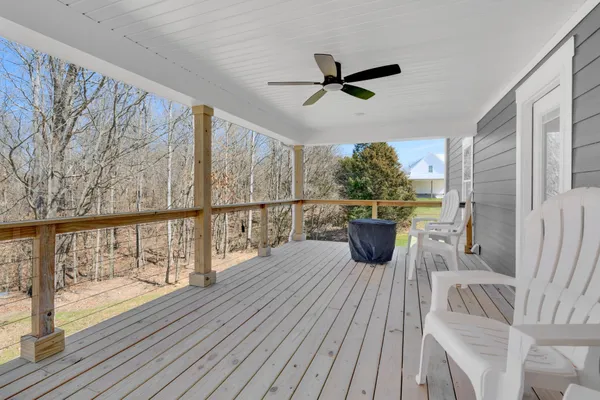 a view of a balcony with wooden floor and outdoor space