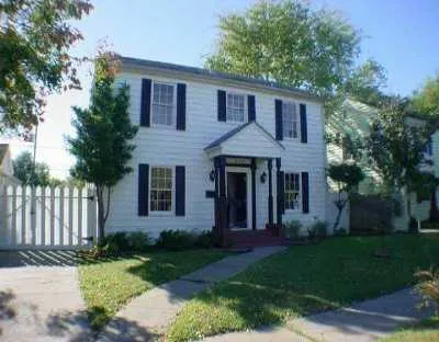 a front view of a house with a yard and porch