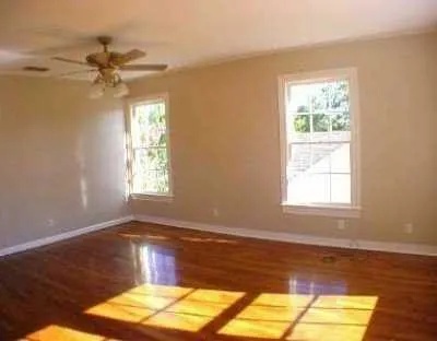 a view of a room with wooden floor and a window