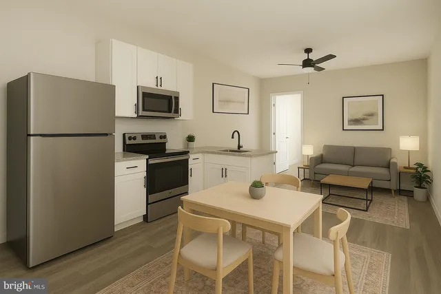 a kitchen with stainless steel appliances a refrigerator a stove a sink a dining table and chairs