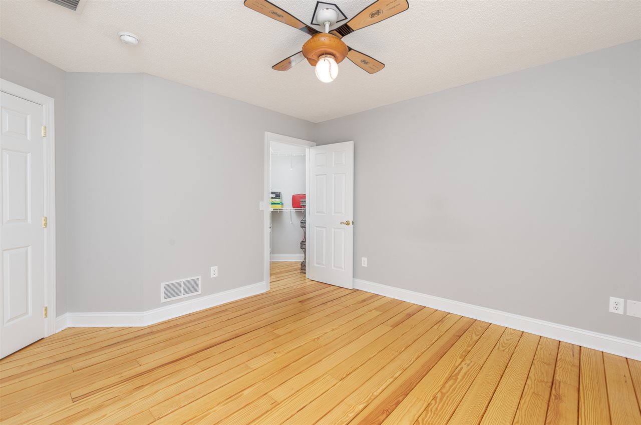 359 Patterson Mill Road Grottoes, VA 24441 - Photo 42 of 50 a view of a room with wooden floor and a ceiling fan