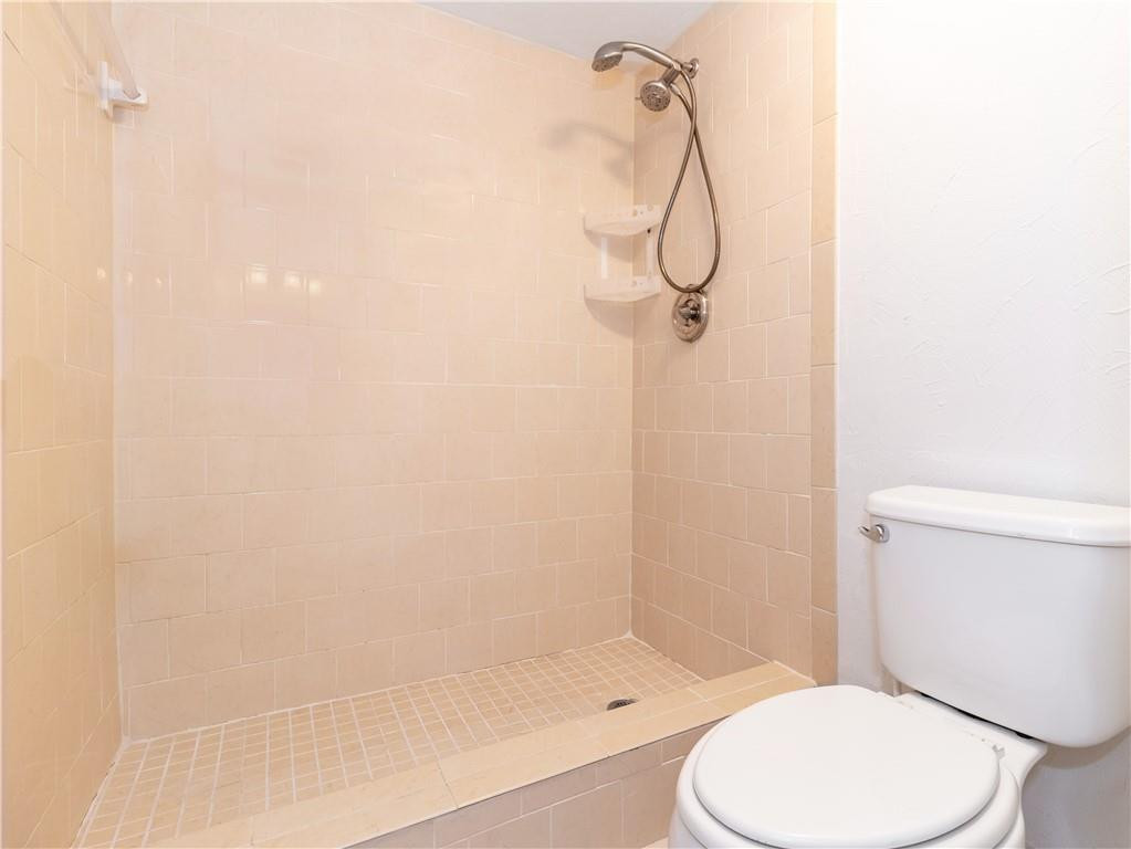 3992 North Pine Island Road, Unit 2A Sunrise, FL 33351 - Photo 11 of 18 a bathroom with a toilet and shower