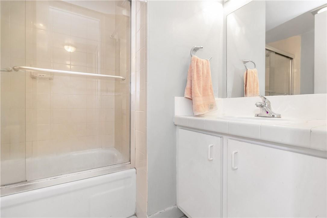 3992 North Pine Island Road, Unit 2A Sunrise, FL 33351 - Photo 14 of 18 a bathroom with a bathtub sink vanity and mirror