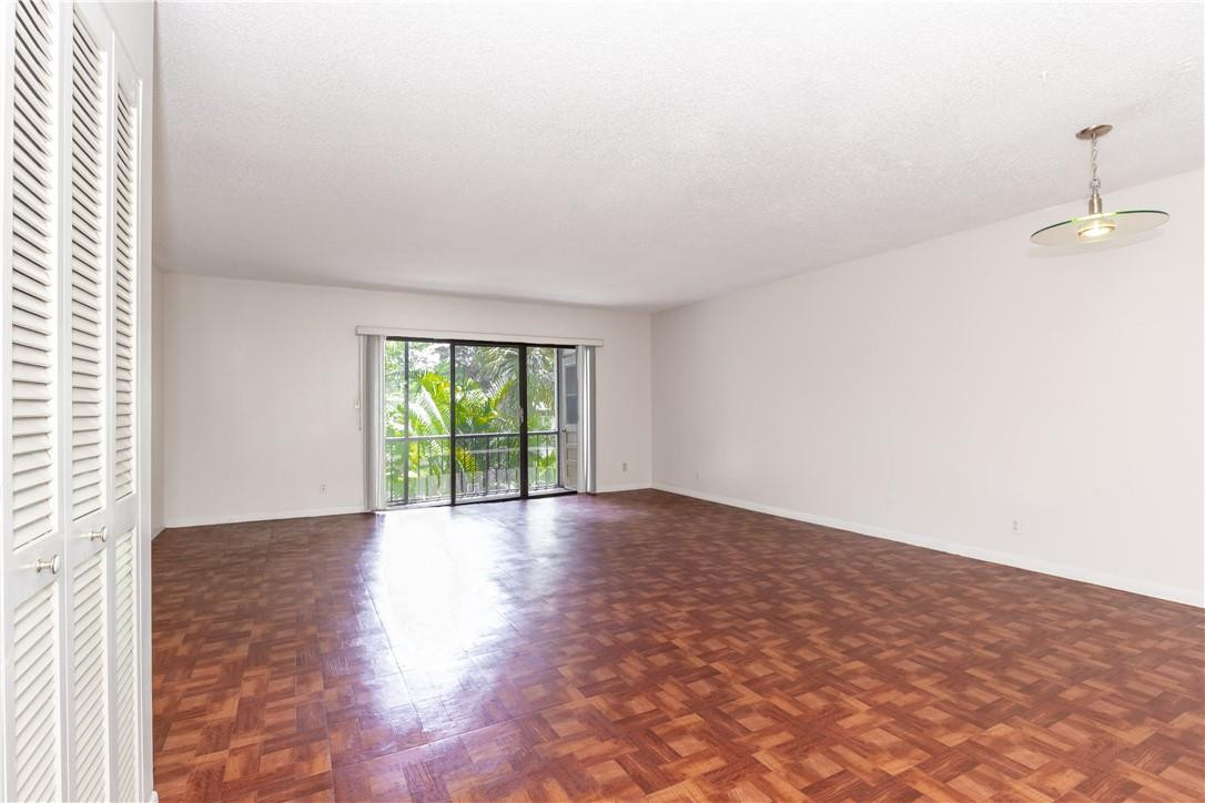 3992 North Pine Island Road, Unit 2A Sunrise, FL 33351 - Photo 3 of 18 a view of an empty room with wooden floor and a window