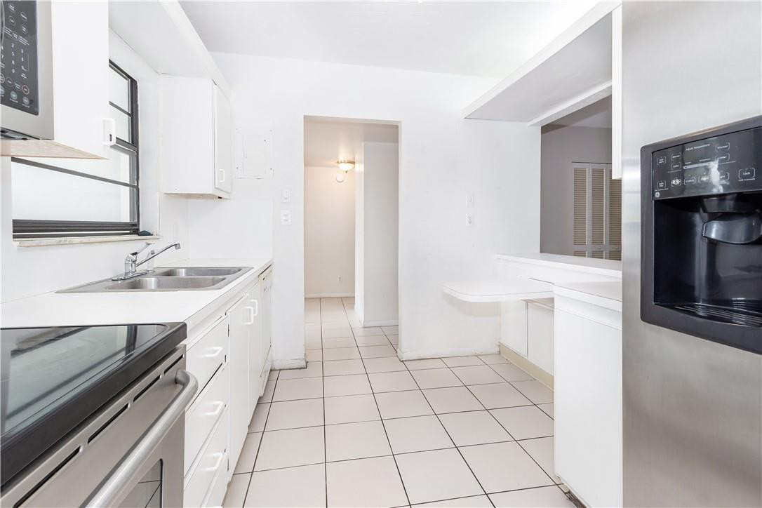 3992 North Pine Island Road, Unit 2A Sunrise, FL 33351 - Photo 6 of 18 a bathroom with a sink mirror and toilet