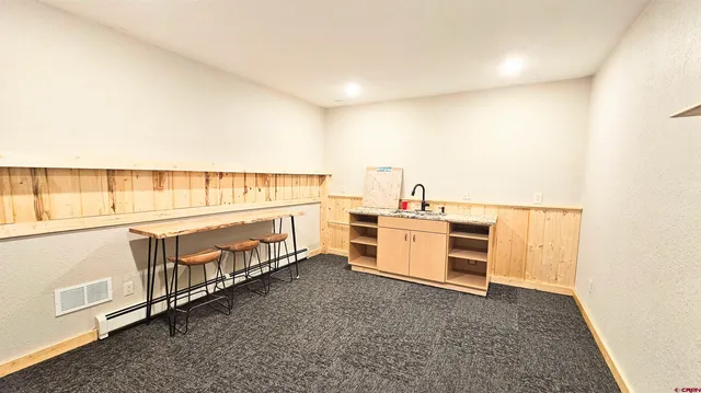 an empty room with chandelier fan