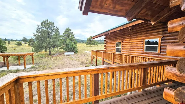 a view of a balcony with wooden floor and outdoor seating