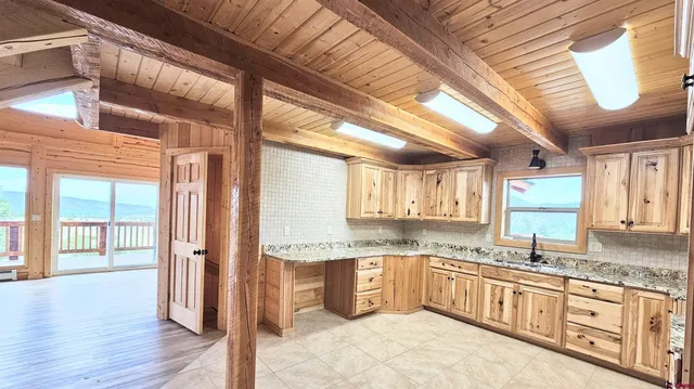 a kitchen with stainless steel appliances granite countertop a stove sink and cabinets