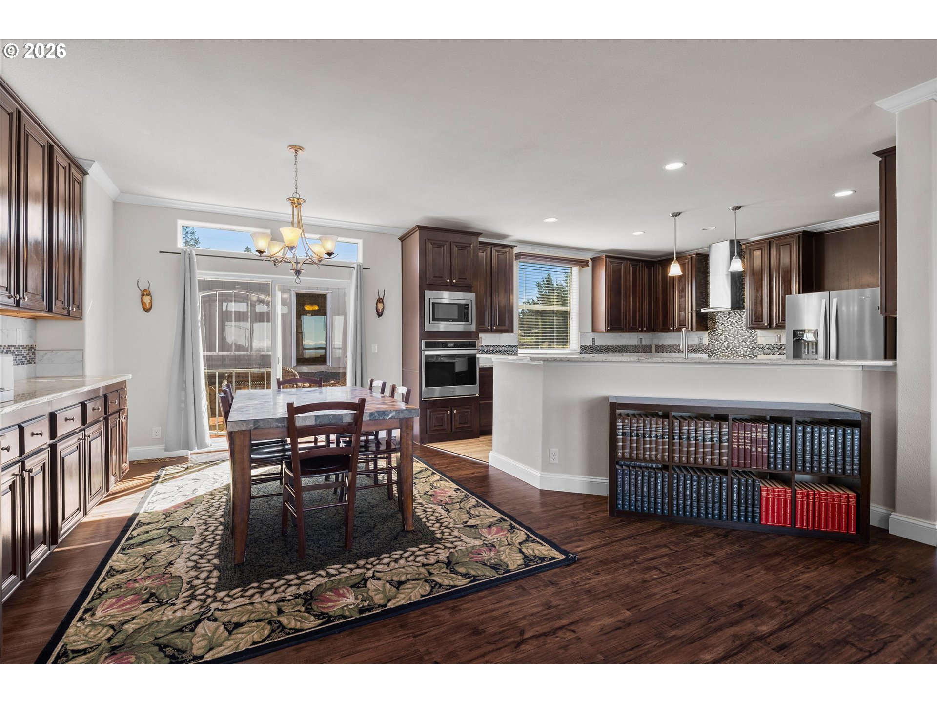 5172 Southeast Oswego Road Prineville, OR 97754 - Photo 5 of 48 a living room with stainless steel appliances kitchen island granite countertop a dining table chairs and granite counter tops