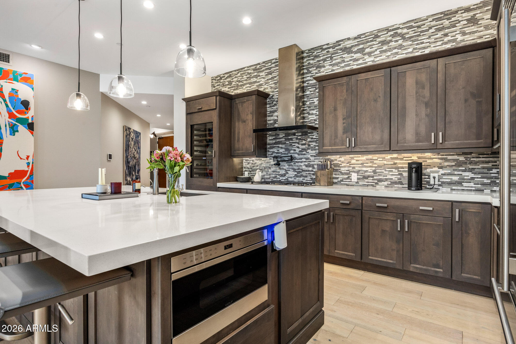 6166 North Scottsdale Road, Unit B1006 Paradise Valley, AZ 85253 - Photo 14 of 43 a kitchen with a sink dishwasher and a stove with wooden floor
