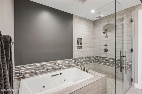 a spacious bathroom with a shower sink and mirror