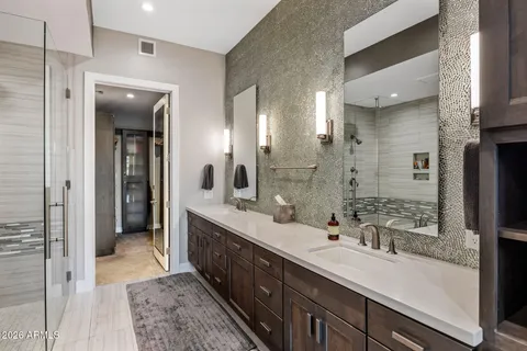 a bedroom with a bed and a large window