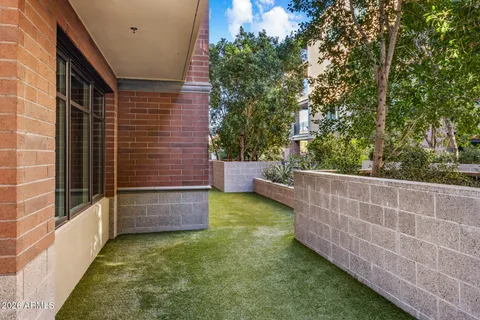 a view of a chair and tables in the backyard of the house