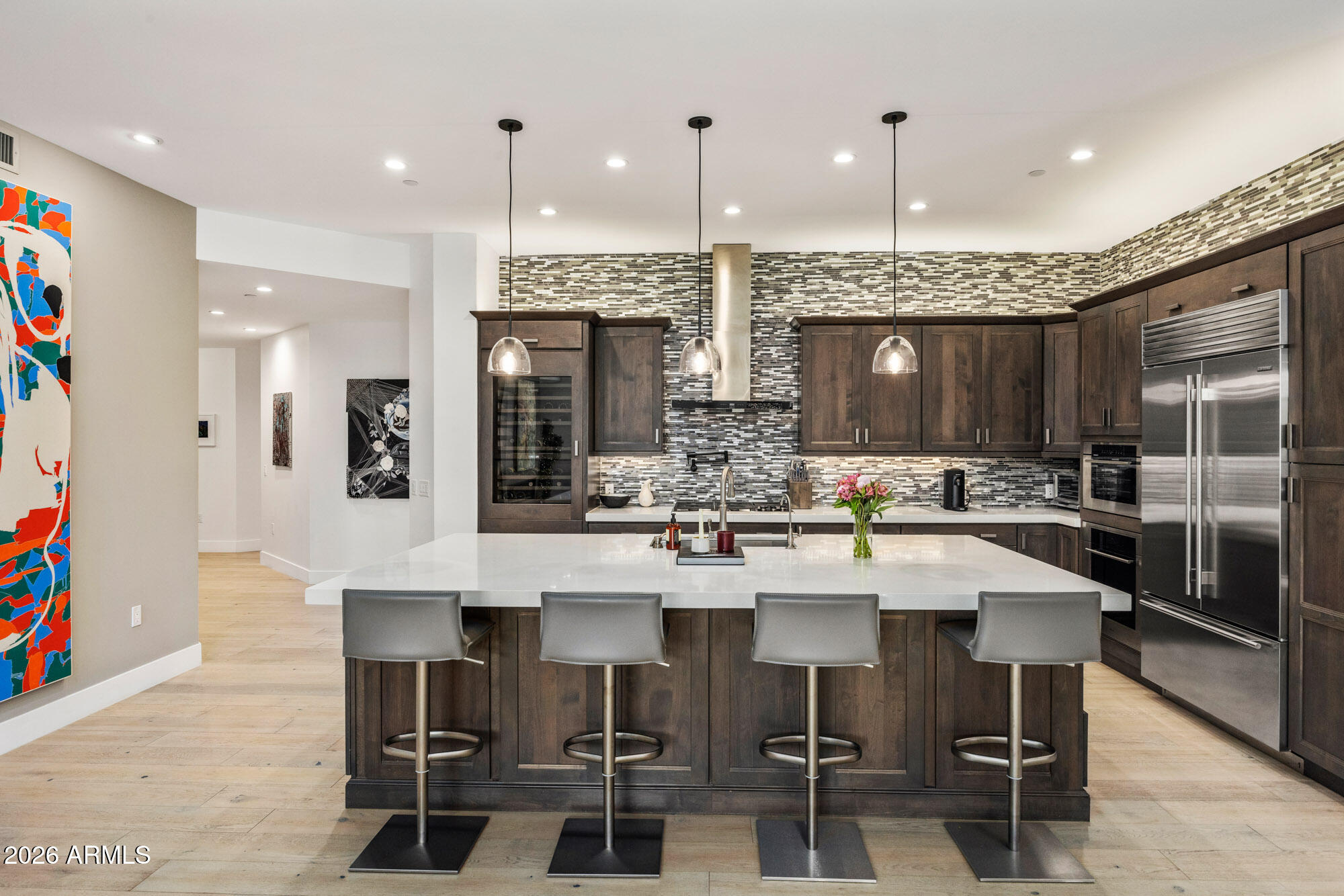6166 North Scottsdale Road, Unit B1006 Paradise Valley, AZ 85253 - Photo 3 of 43 a kitchen with stainless steel appliances kitchen island granite countertop a sink and cabinets