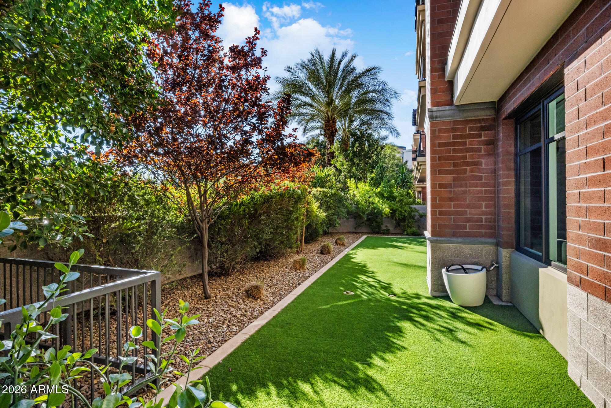 6166 North Scottsdale Road, Unit B1006 Paradise Valley, AZ 85253 - Photo 31 of 43 a view of a chair and tables in the backyard of the house