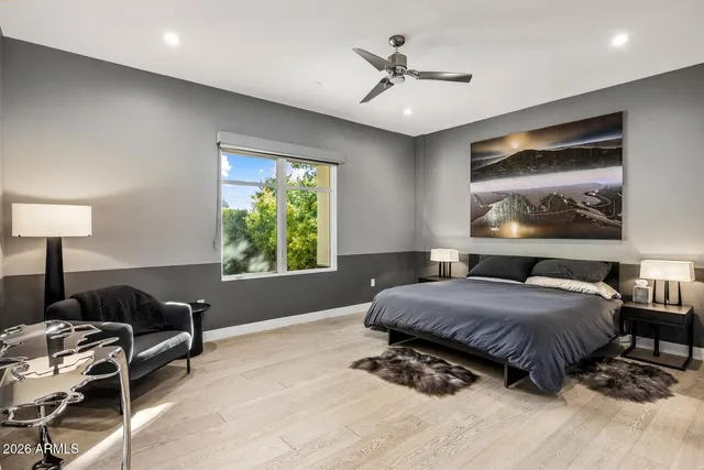 a spacious bedroom with a bed a couch and a window