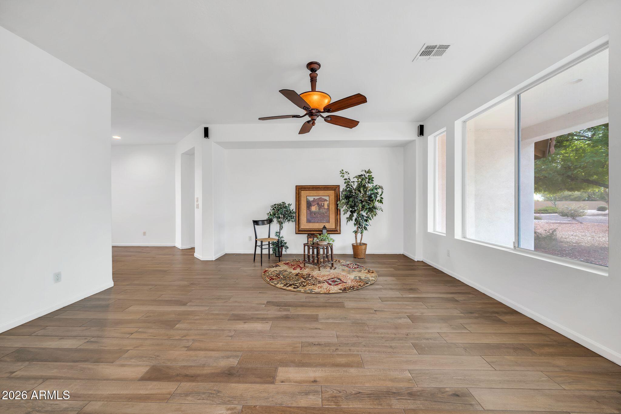 16435 West Berkeley Road Goodyear, AZ 85395 - Photo 10 of 52 a view of a dining room with a table and chairs