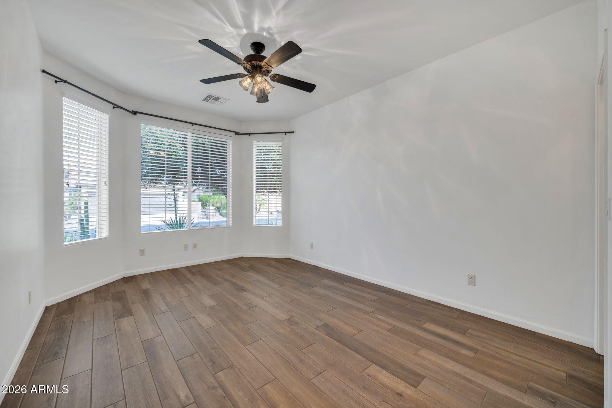 16435 West Berkeley Road Goodyear, AZ 85395 - Photo 15 of 52 wooden floor in an empty room with a window