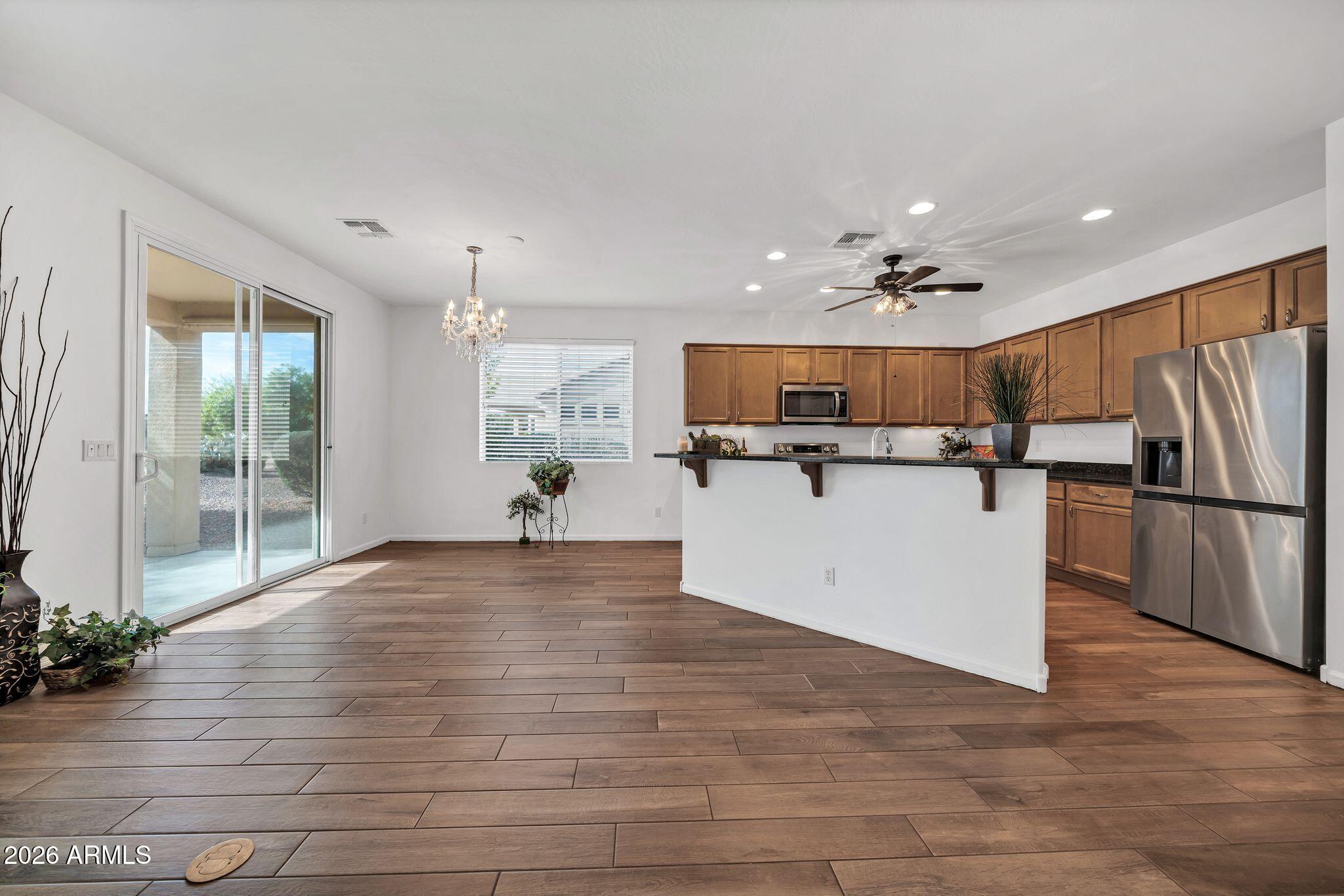 16435 West Berkeley Road Goodyear, AZ 85395 - Photo 3 of 52 a view of kitchen with cabinets microwave and refrigerator