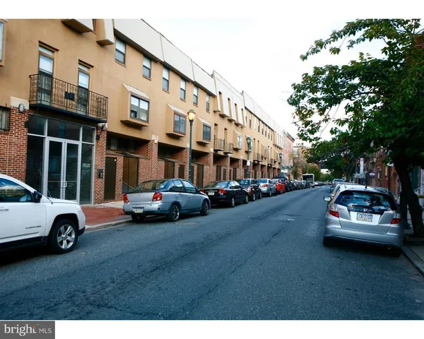 a car parked in front of a white house