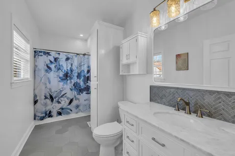 a bathroom with a sink toilet and shower